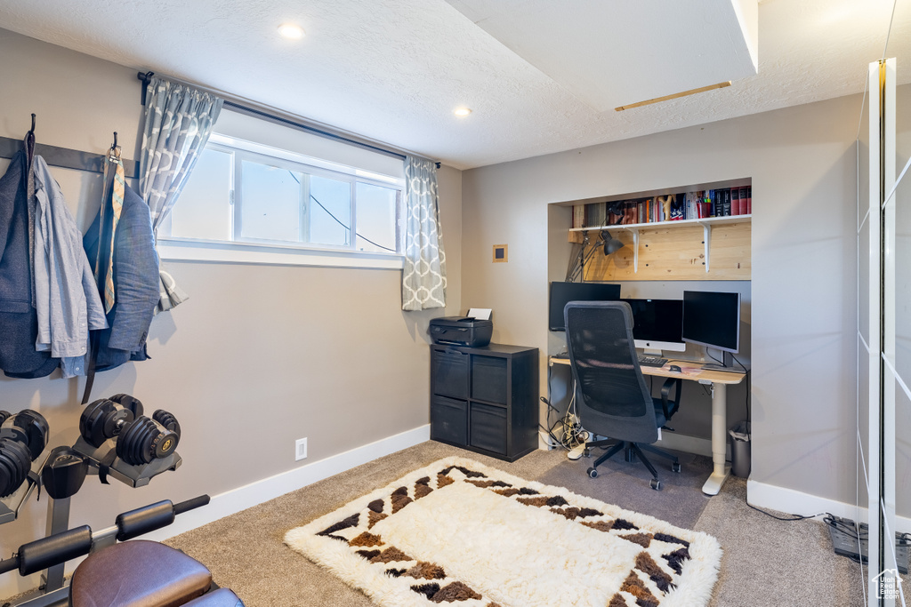 Carpeted office space featuring baseboards and recessed lighting