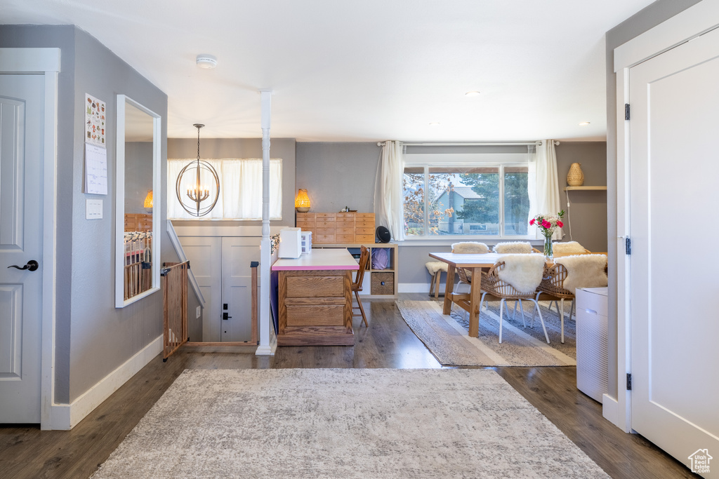 Entrance foyer featuring wood finished floors and a chandelier