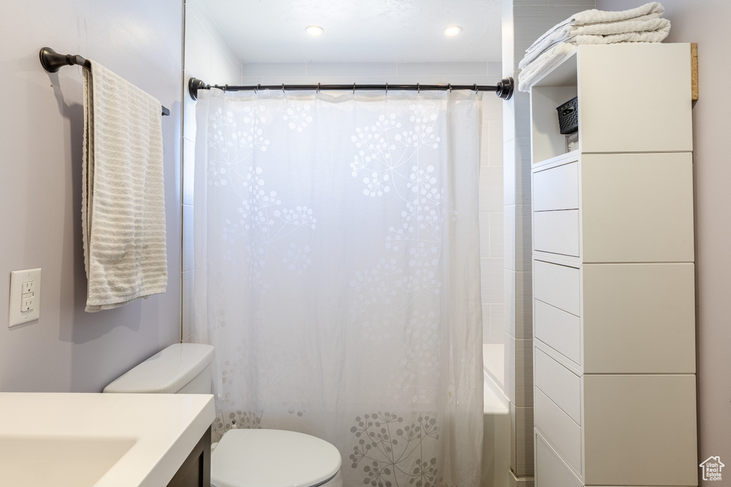 Full bathroom with vanity and shower / bath combo with shower curtain