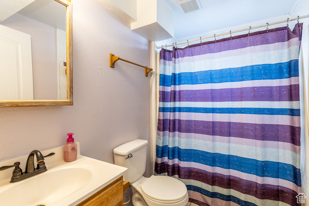 Full bath featuring vanity and curtained shower