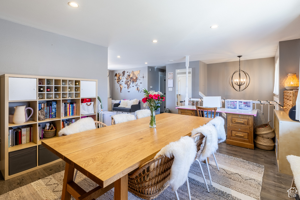 Dining space with a chandelier, wood finished floors, and recessed lighting