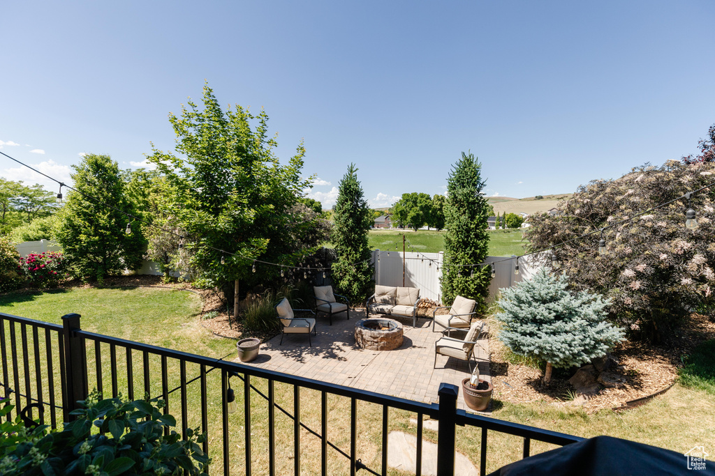 Fenced backyard with an outdoor fire pit and a patio area