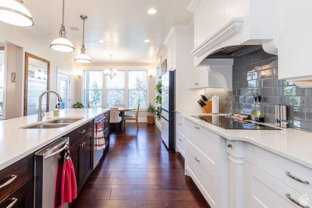 Kitchen with dishwasher, black electric stovetop, recessed lighting, white cabinetry, and backsplash