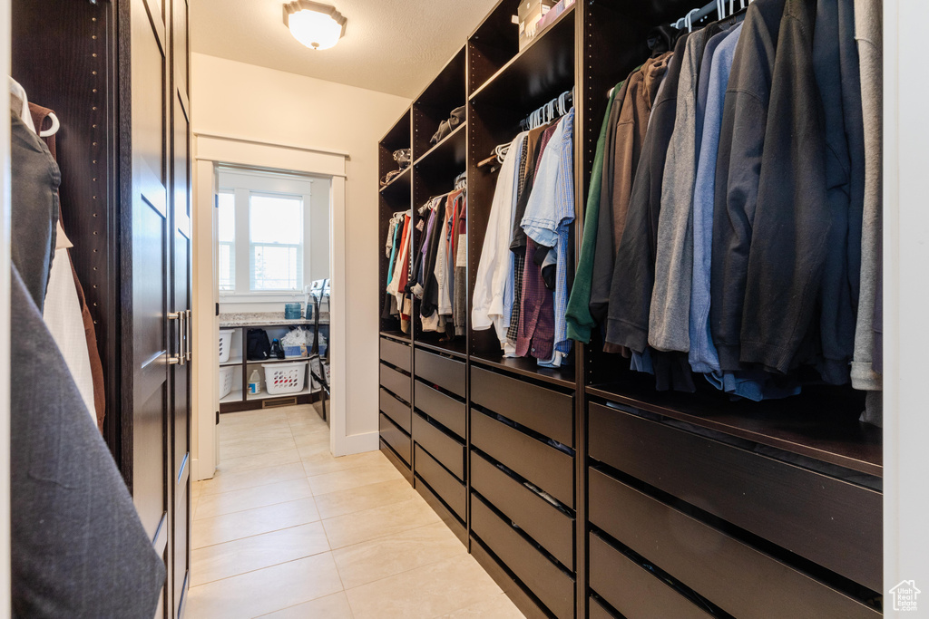 Spacious closet with light tile patterned flooring