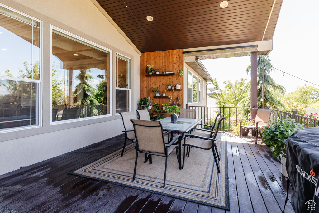 Wooden deck featuring outdoor dining area
