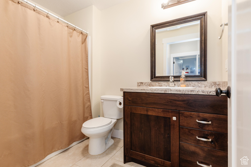 Full bath with tile patterned flooring, vanity, and a shower with shower curtain