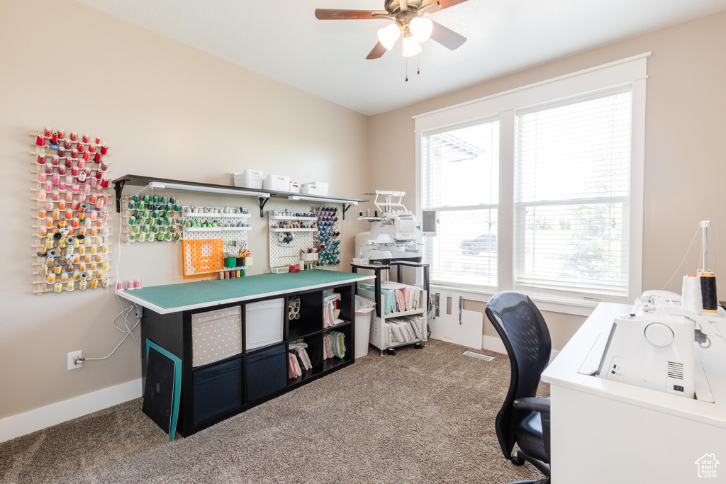 Home office featuring carpet flooring and a ceiling fan