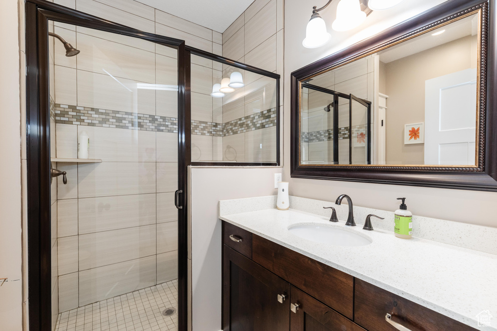 Bathroom with a shower stall and vanity