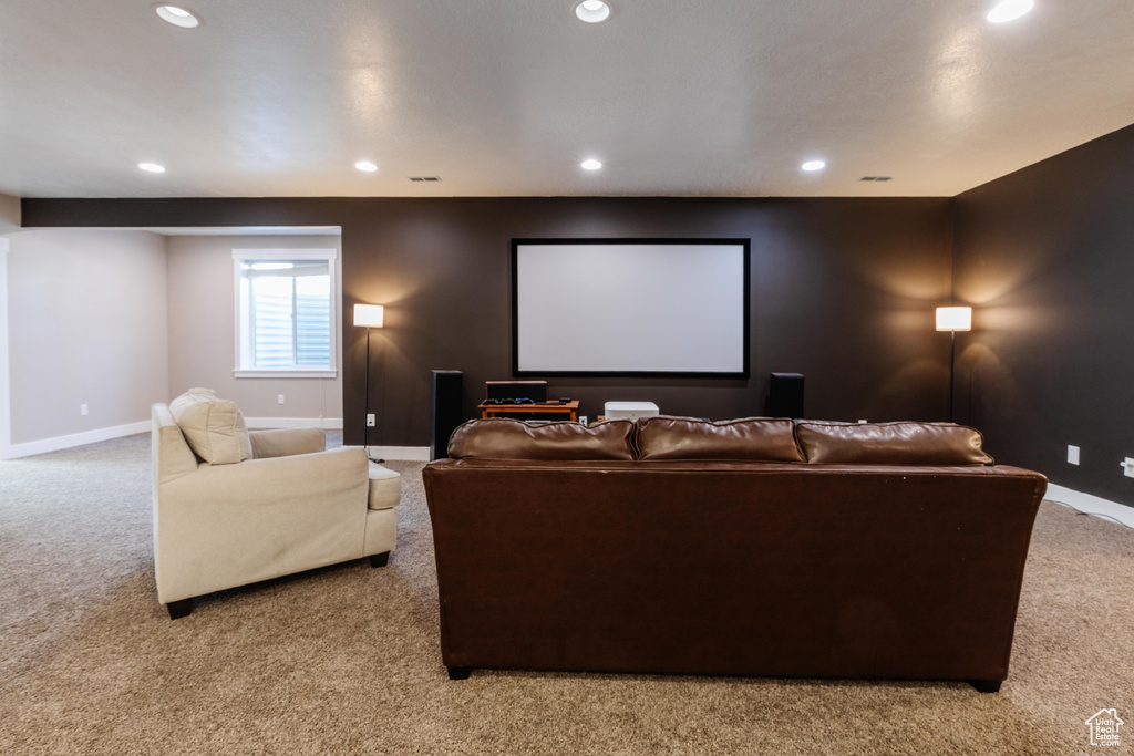 Home theater room with light carpet and recessed lighting