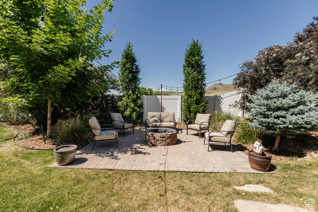 View of patio with a fire pit