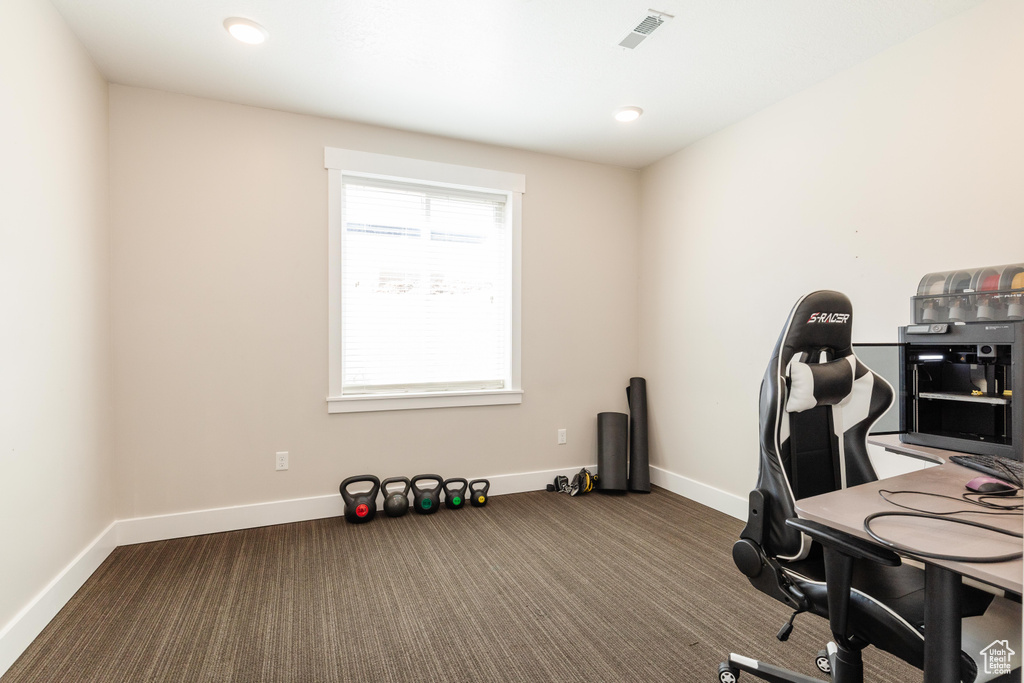 Office area featuring carpet floors and baseboards