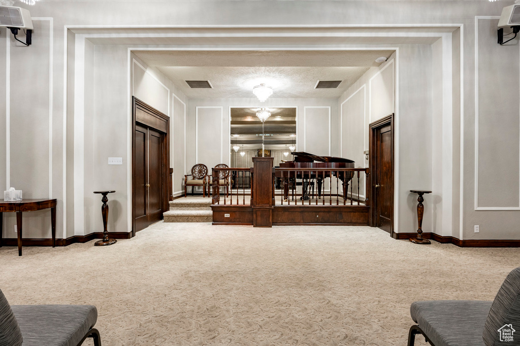 Carpeted bedroom with baseboards and a decorative wall