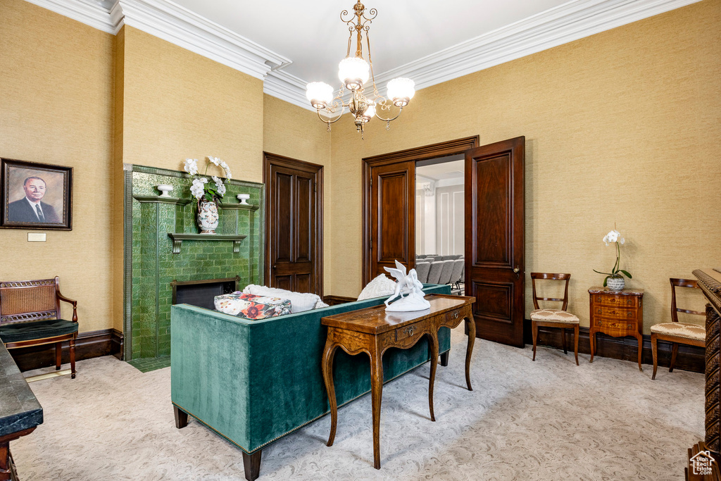 Living area featuring light colored carpet, crown molding, a chandelier, and a fireplace