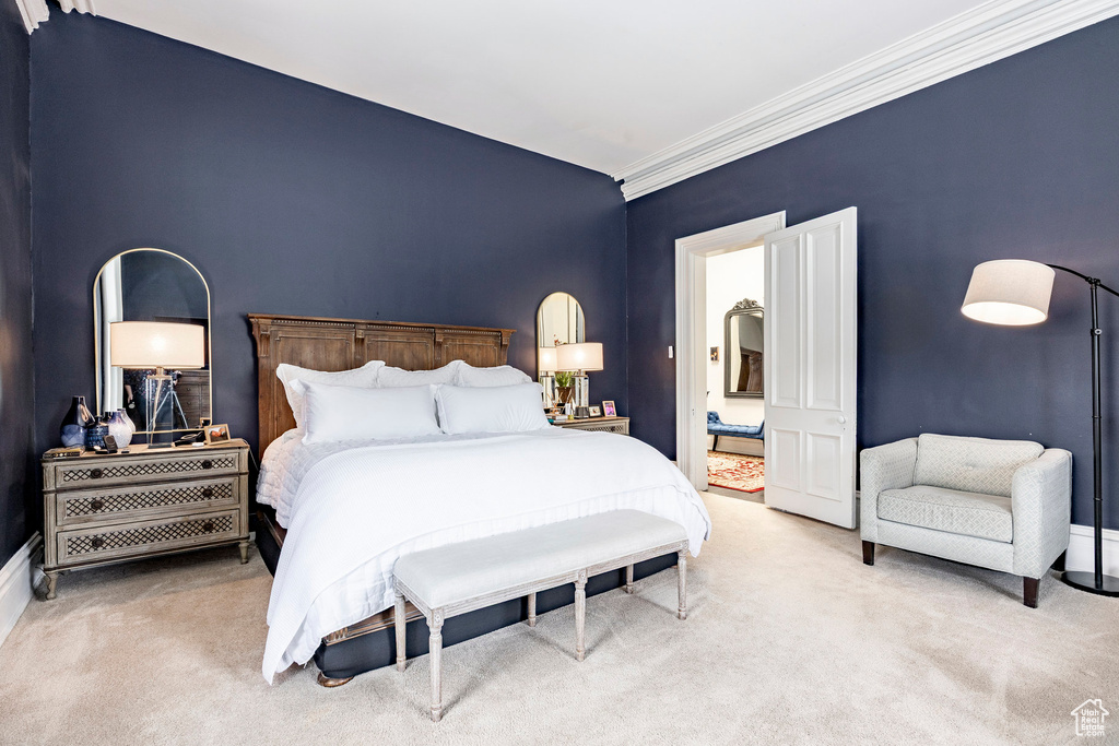 Carpeted bedroom featuring ornamental molding and baseboards
