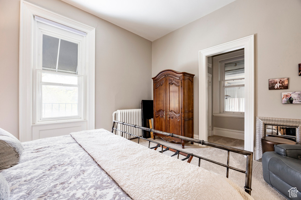 Bedroom featuring carpet and radiator heating unit