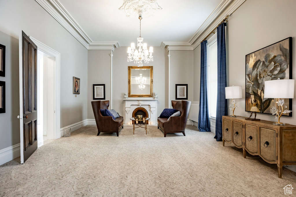 Sitting room with carpet floors, a chandelier, and ornamental molding