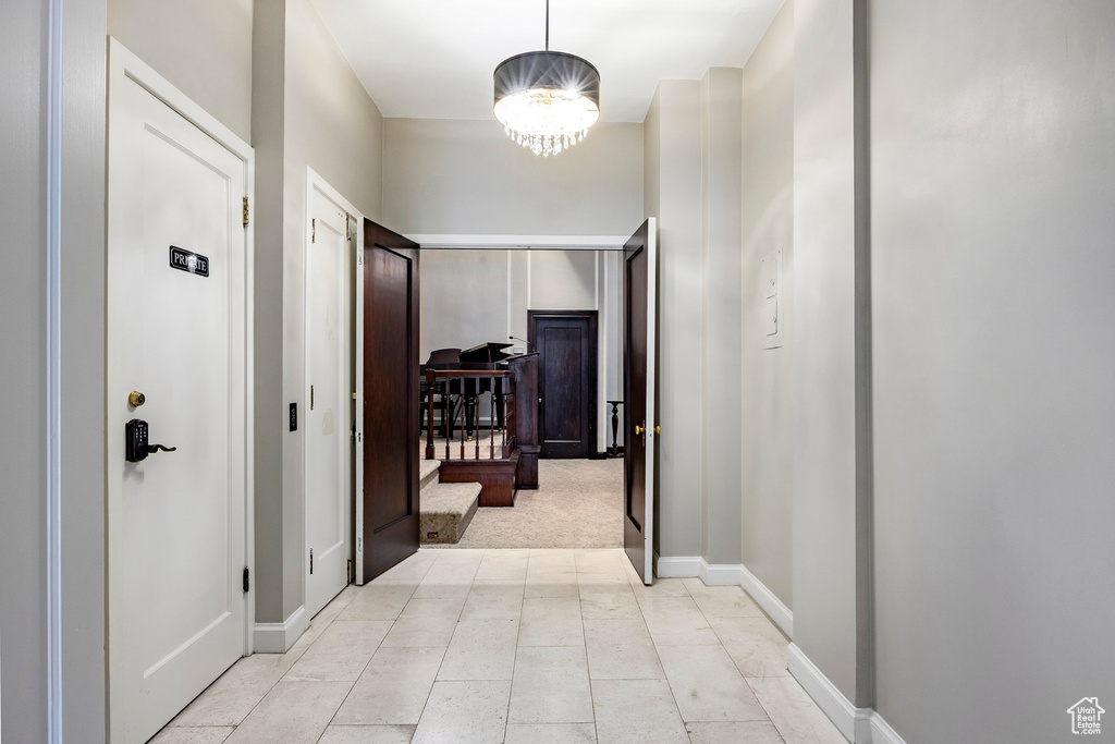 Hall with light carpet and baseboards