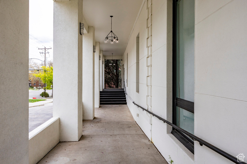 Hallway featuring a chandelier and stairs