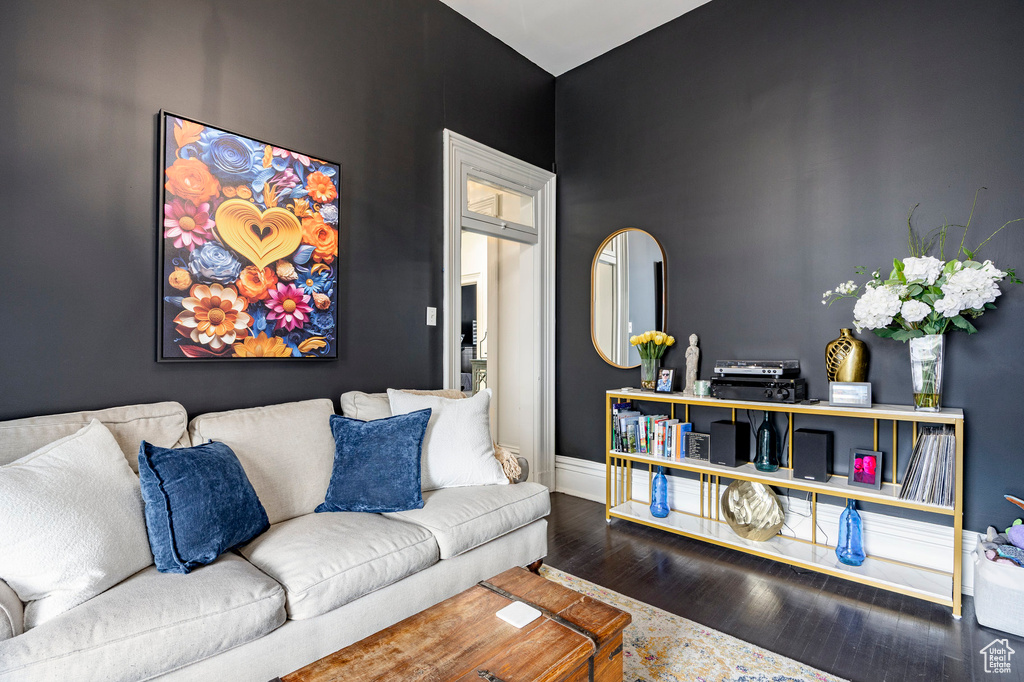 Living area with wood finished floors and baseboards