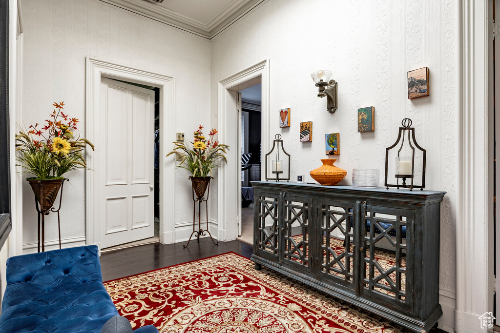 Foyer featuring ornamental molding and wood finished floors