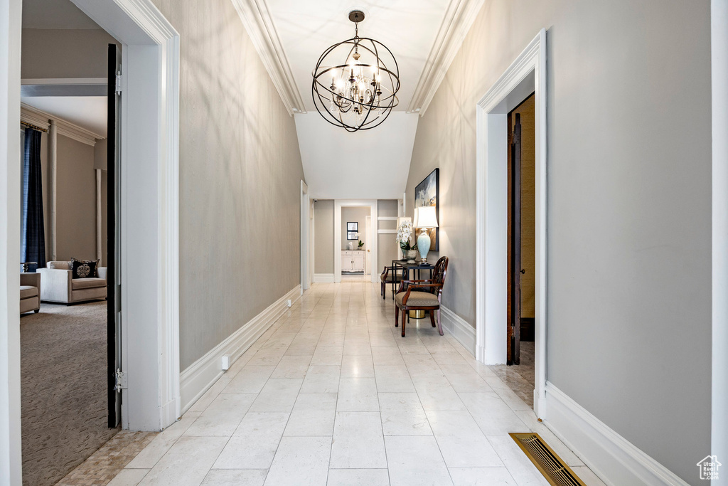 Hall with a chandelier and ornamental molding