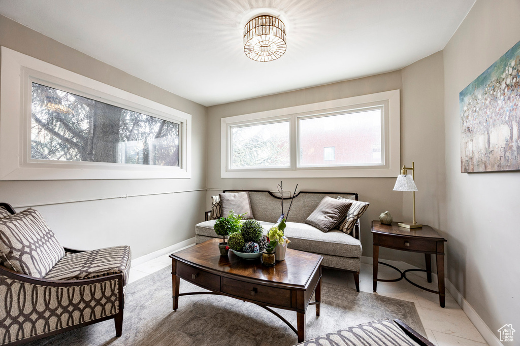 Living area with baseboards and light tile patterned floors