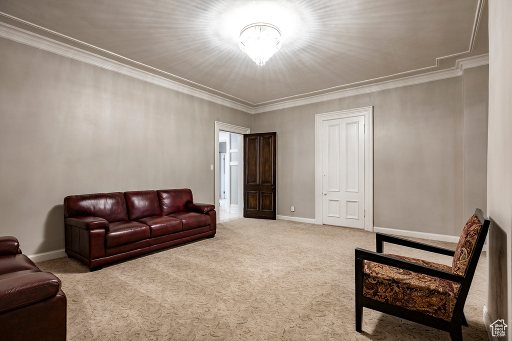 Carpeted living room with baseboards and ornamental molding