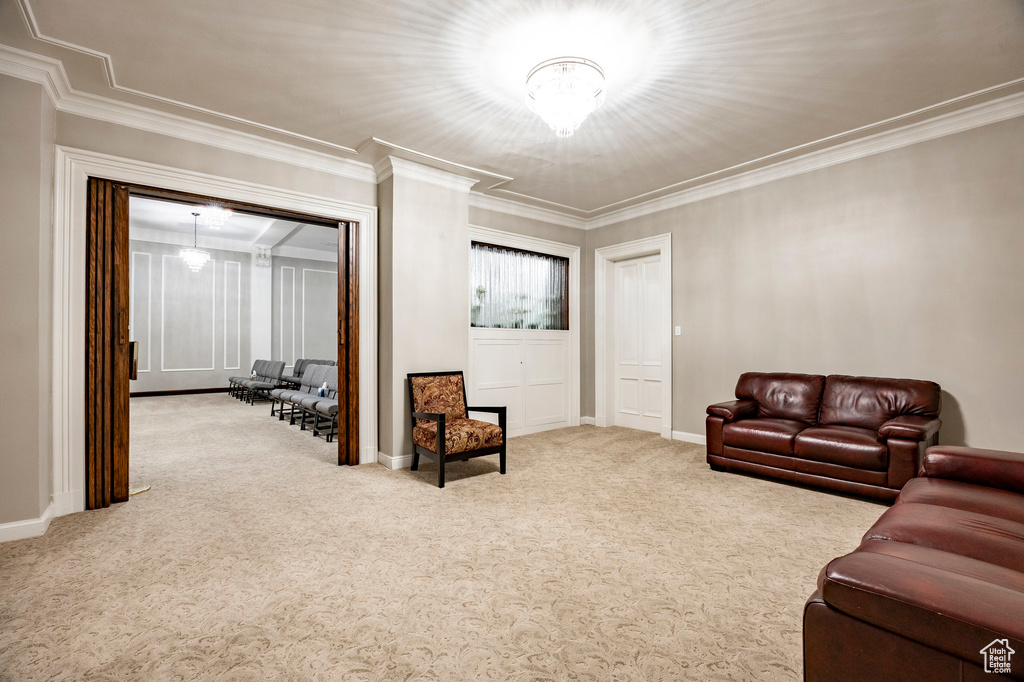 Carpeted living room with baseboards and ornamental molding