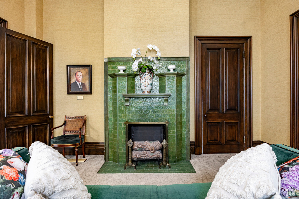Carpeted living room featuring a fireplace