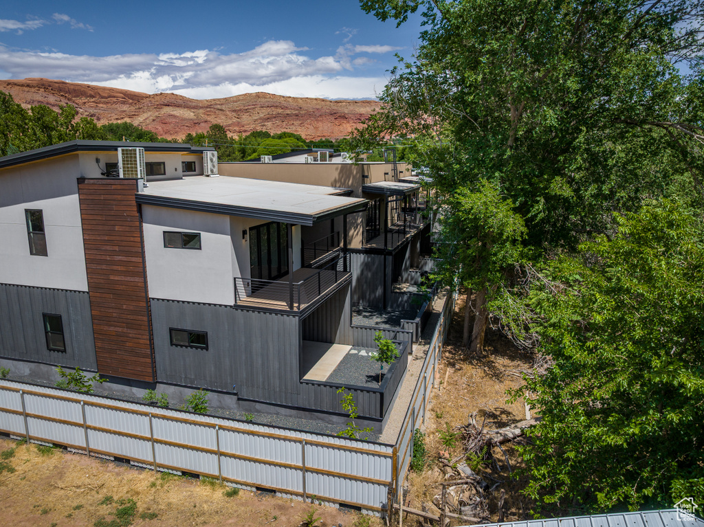 Rear view of property featuring a balcony and a mountain view