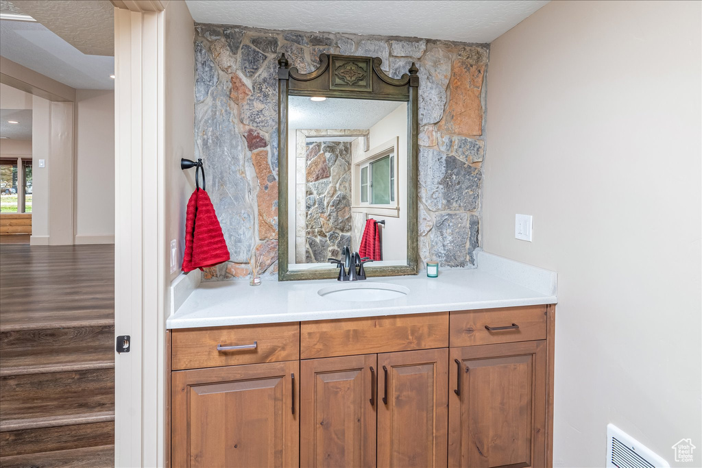 Bathroom with vanity and a textured ceiling