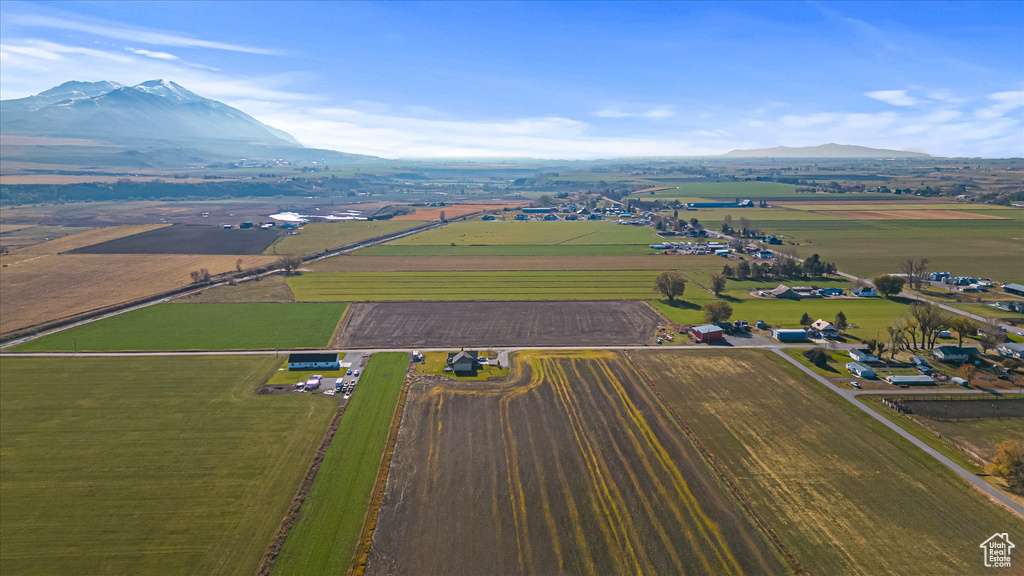 View of rural area with a mountain backdrop and large plots for crops