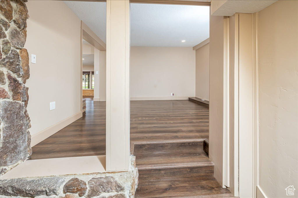 Stairway featuring wood finished floors