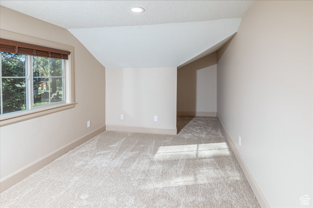 Bonus room featuring lofted ceiling, carpet flooring, a textured ceiling, and recessed lighting