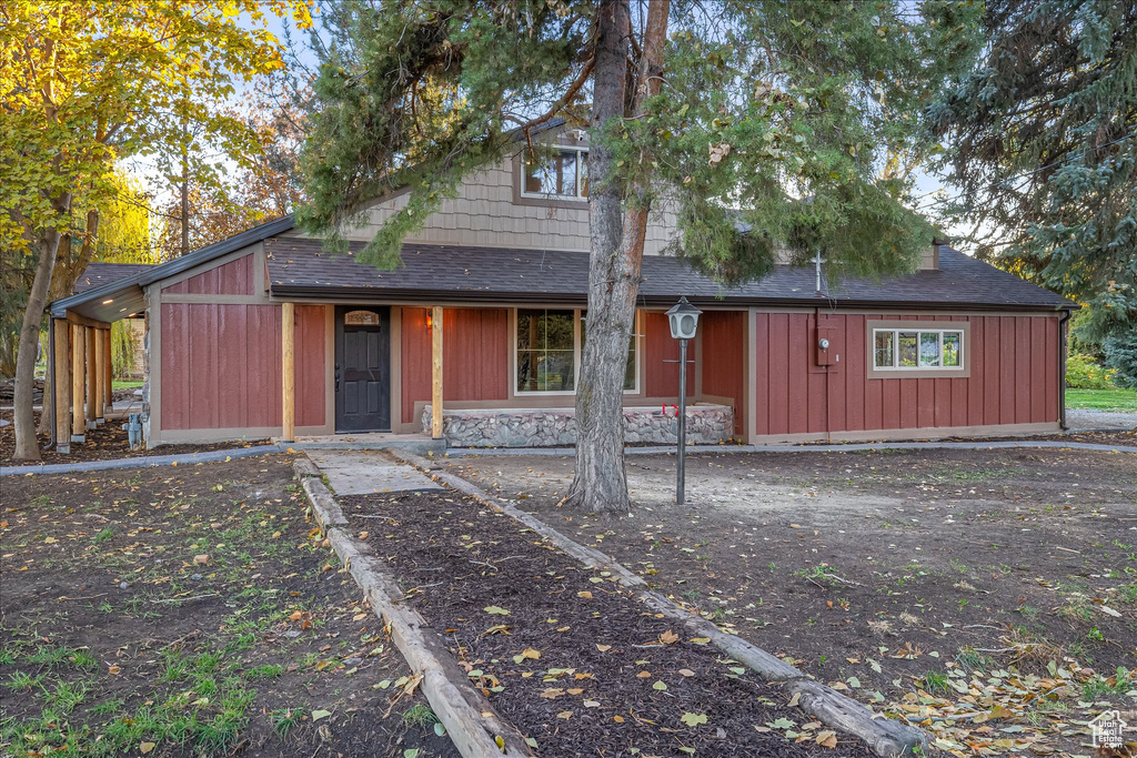 View of front of home featuring a shingled roof