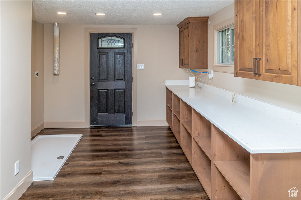 Entryway featuring a textured ceiling, dark wood-style floors, and recessed lighting