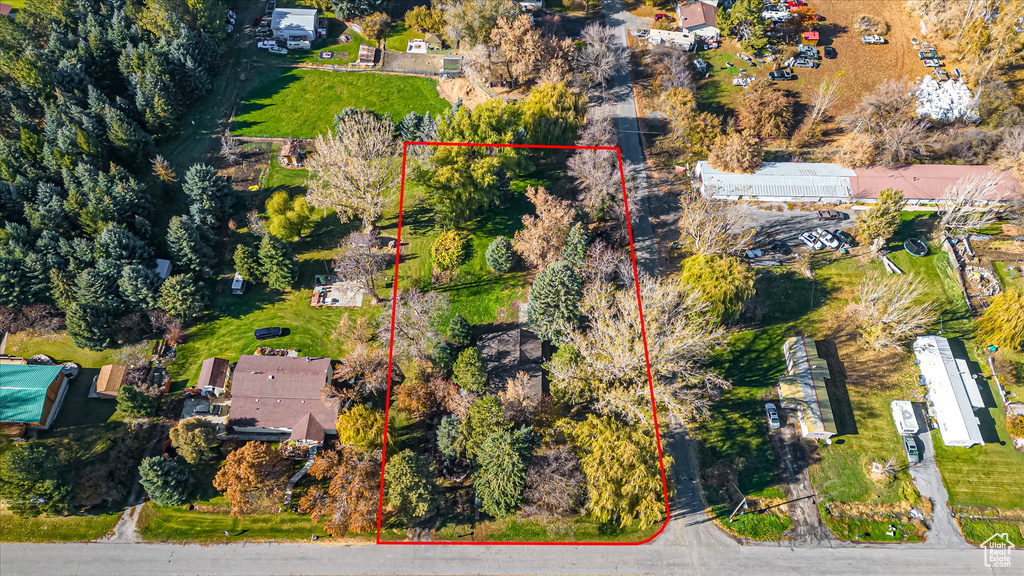 Aerial view of property and surrounding area featuring property parcel outlined