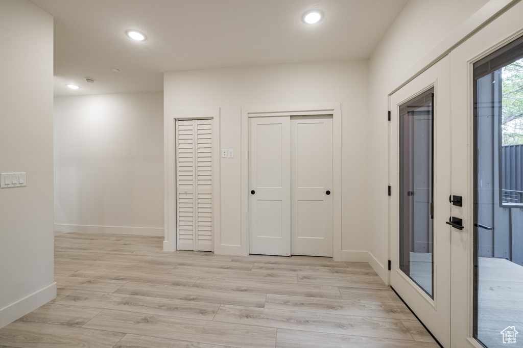 Corridor with recessed lighting, baseboards, and light wood-style flooring