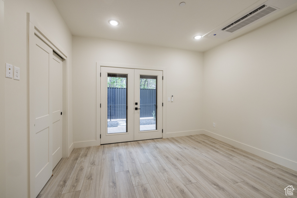 Entryway with light wood-type flooring, french doors, baseboards, and recessed lighting
