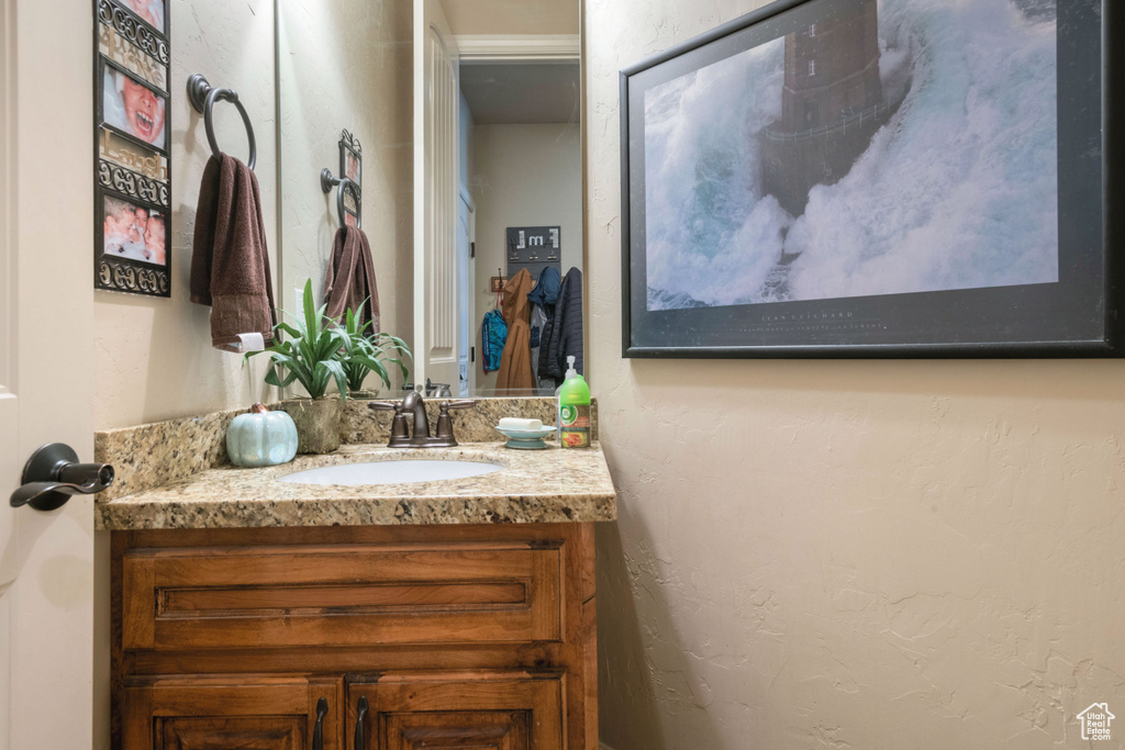 Bathroom with vanity and a textured wall