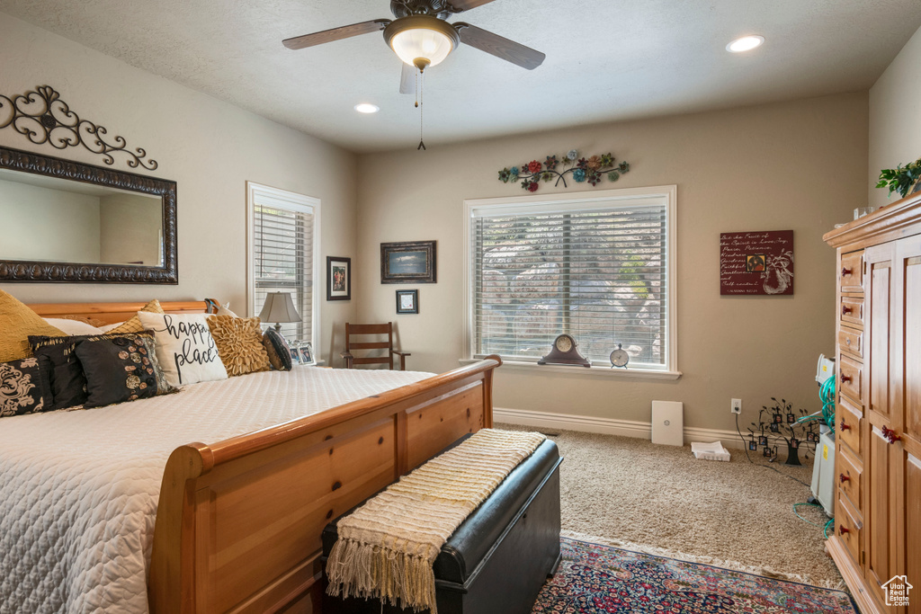 Carpeted bedroom with recessed lighting and a ceiling fan