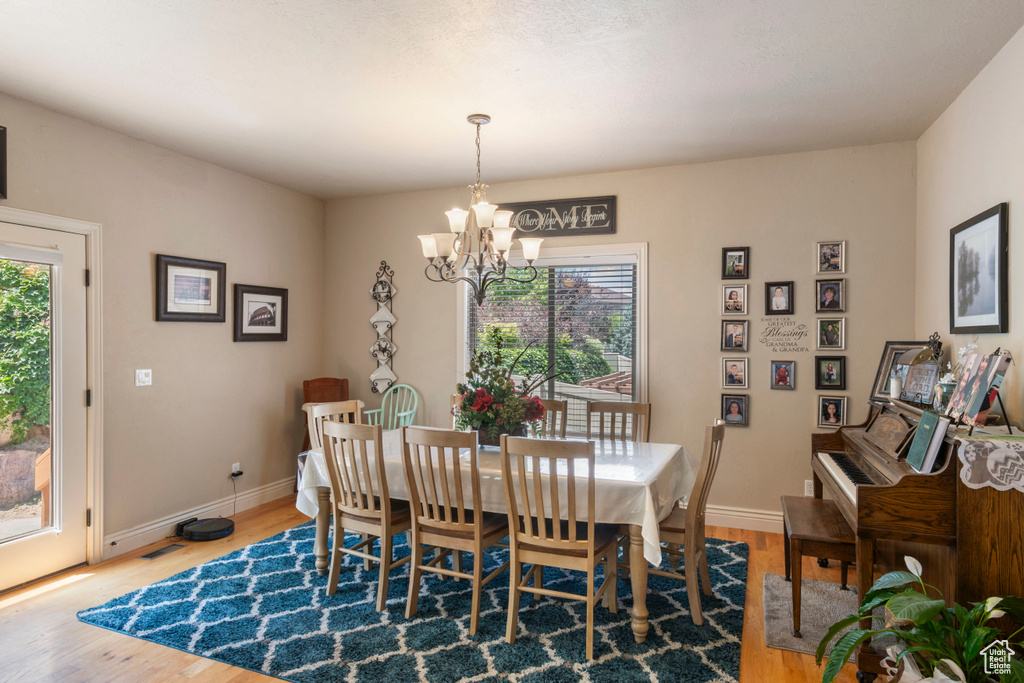 Dining area featuring a chandelier and wood finished floors
