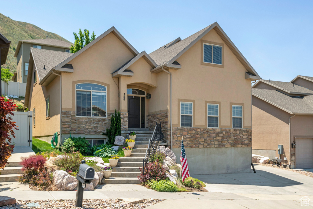 View of front of property with stone siding and stucco siding