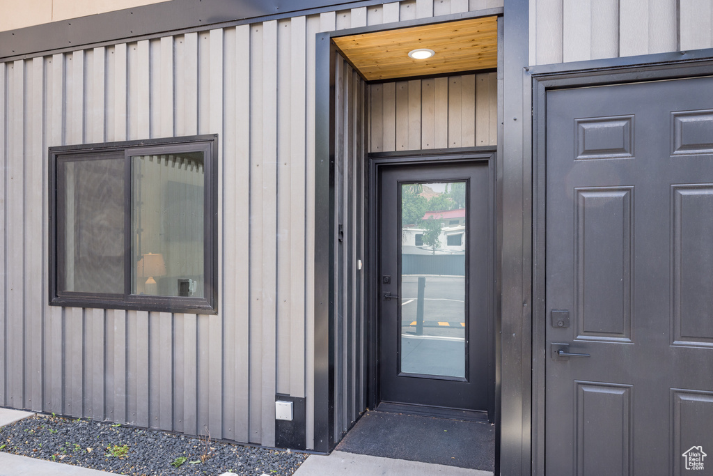 Property entrance featuring board and batten siding