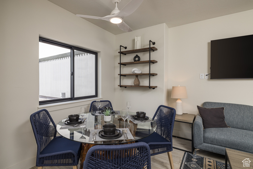 Dining space with wood finished floors, plenty of natural light, and ceiling fan
