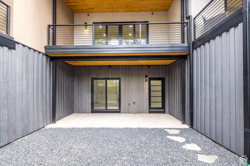 Back of house featuring a balcony and a patio area