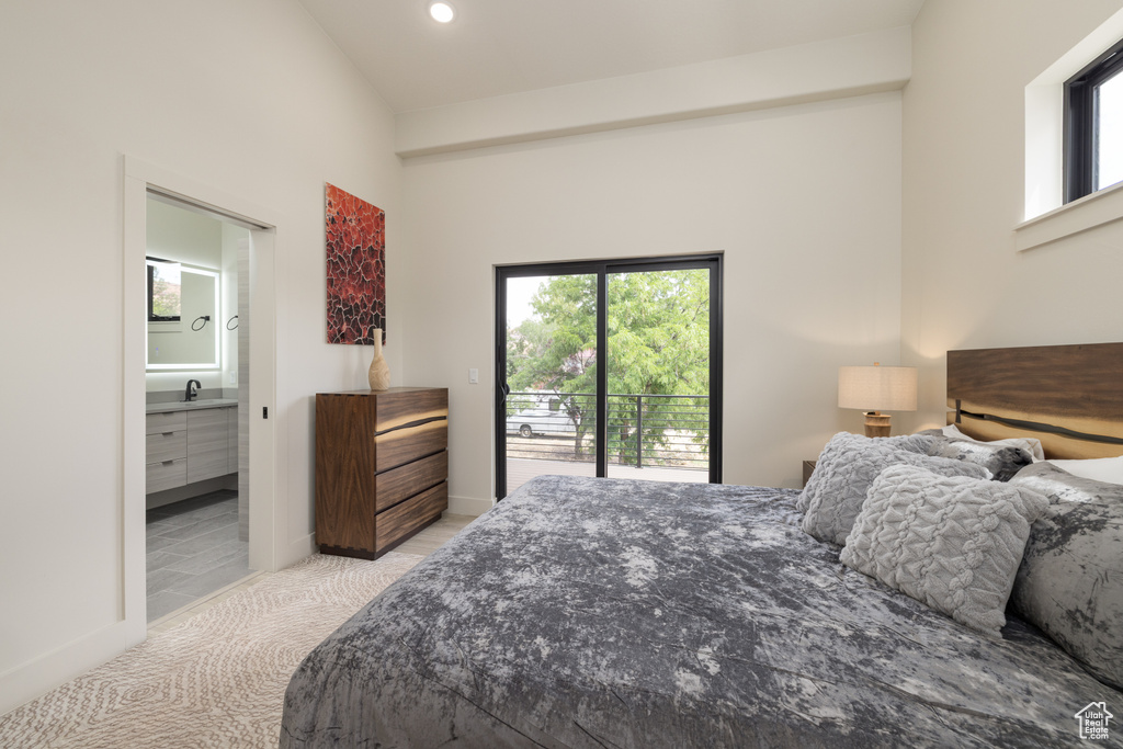Bedroom featuring access to exterior, multiple windows, a sink, light carpet, and recessed lighting