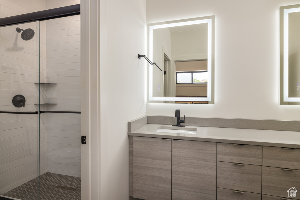 Full bathroom featuring a shower stall and vanity