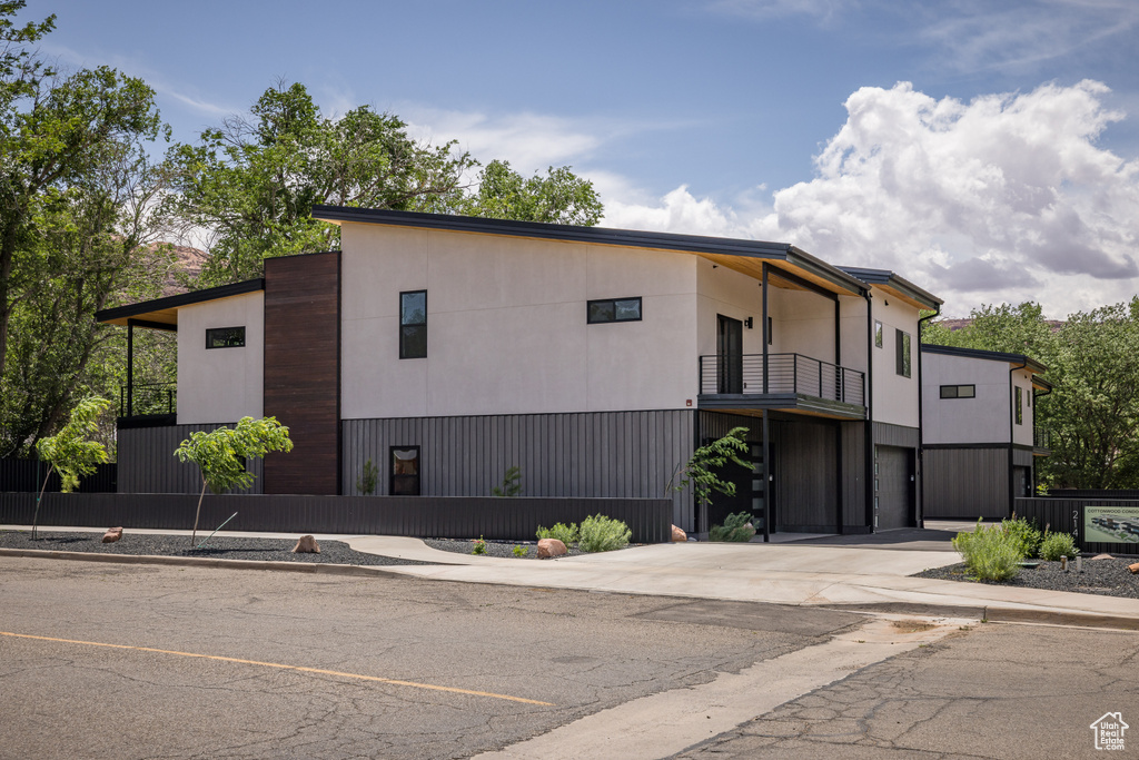 View of property with concrete driveway