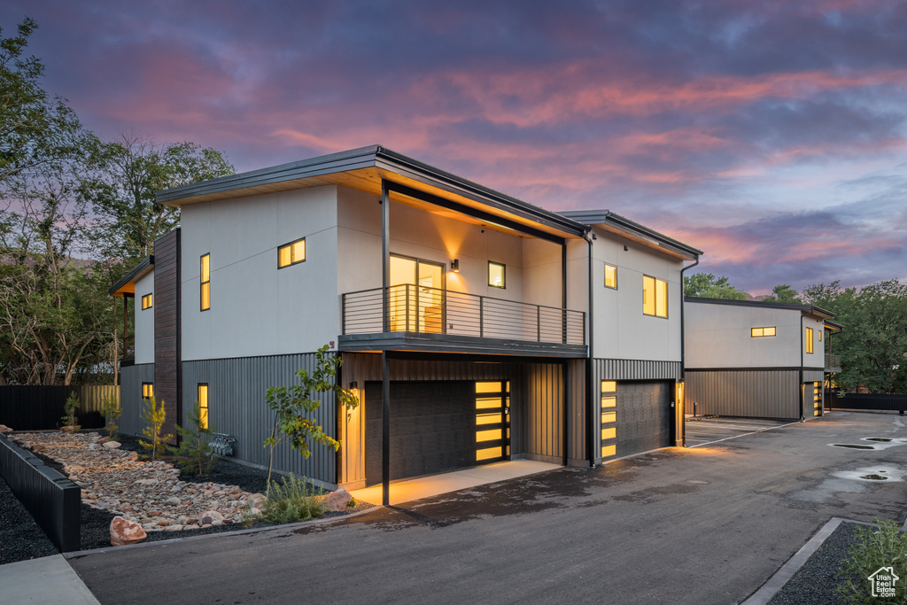 Modern home featuring a balcony and a garage